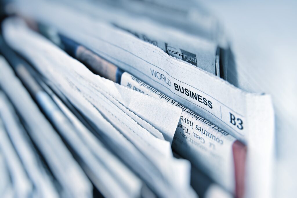 a newspaper pile with the section business in view